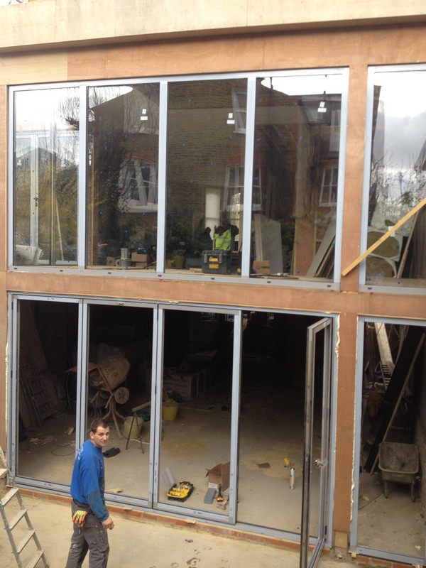 Aluminium bi-fold doors with two-storey glazing in Bushey