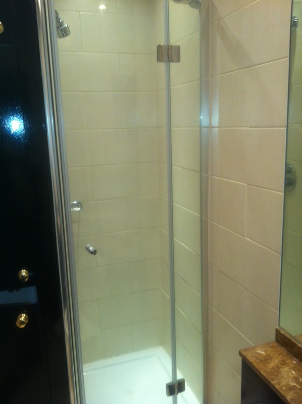 Frameless glass shower enclosure with chrome fittings in Bushey