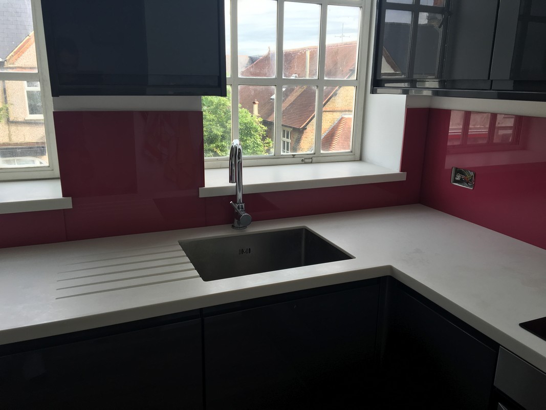 Deep plum coloured glass splashback in modern Bushey kitchen